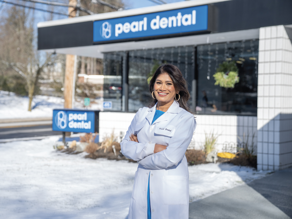 Dr. Channamsetty stands outside one of the locations of Pearl Dental.