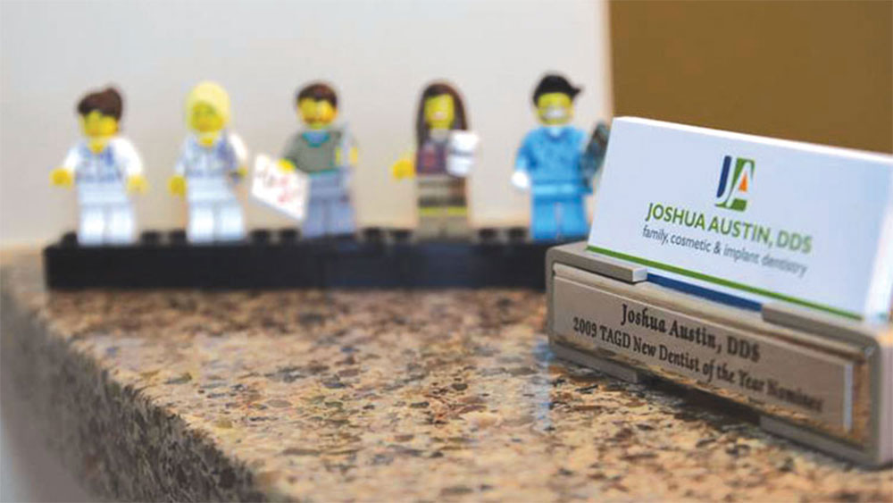 Dr. Joshua Austin's office card holder with his favorite Lego people set