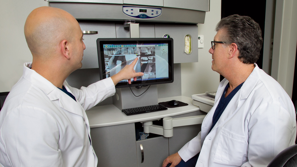 Director of Clinical Research and Development Dr. Siamak Abai discuss an implant case with Dr. Park