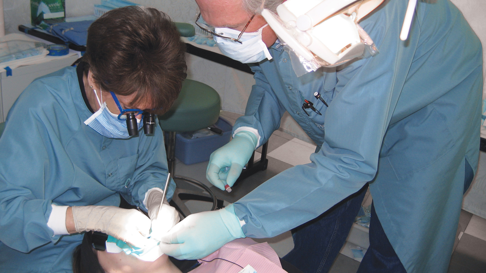 Dr. Christensen and Brad Ploeger, a virologist with TRAC Research, performing a sterile harvest of microorganisms from an active caries lesion in an adult patient.
