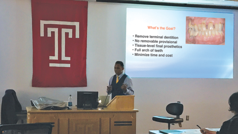 Dr. Paresh Patel speaks about full-arch implant restorations during a continuing education course at Temple University in April.