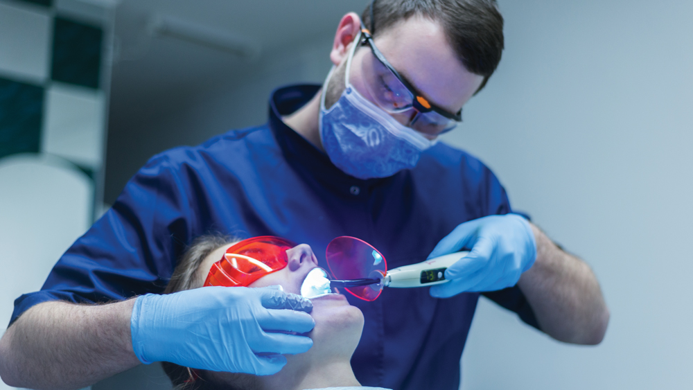 Dentist scanning patient's teeth