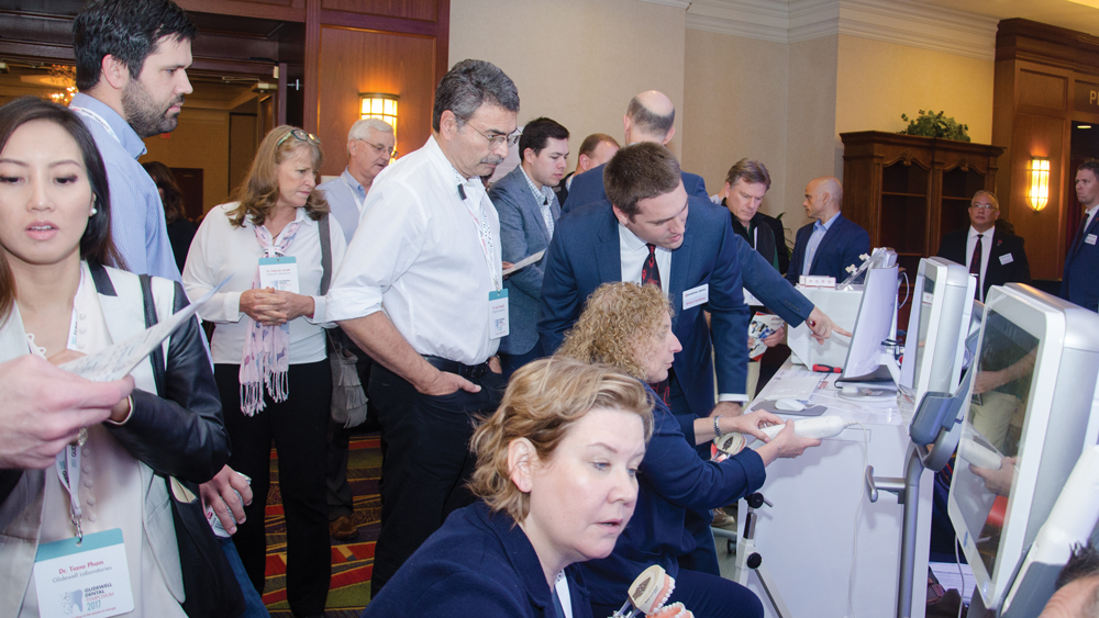 Attendees reviewing the iTero Element scanner
