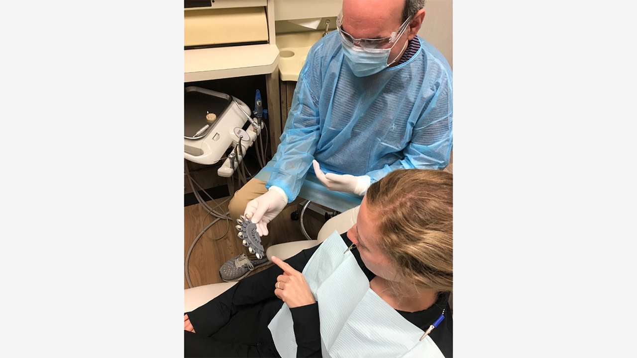Dr. Adam Goldberg showing the BruxZir Shade Guide to a patient