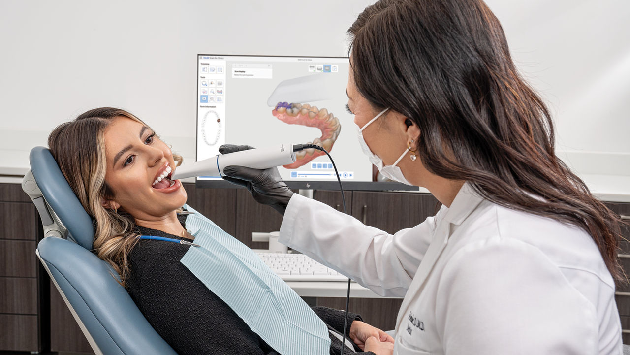 Dentist Using Scanner On Patient