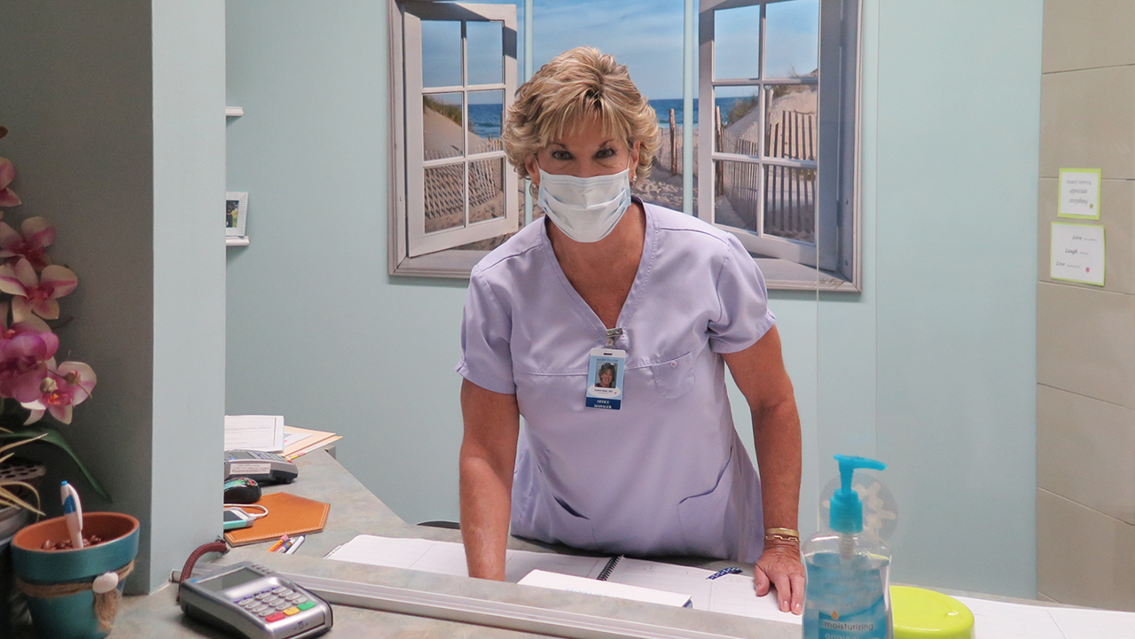Staff members at Dr. Stephen Blank's practice wearing name badges with their photos on them to comfort new patients.