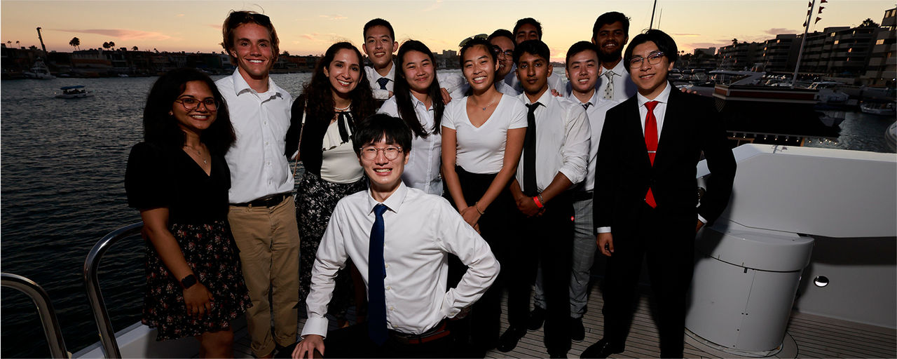 Group of interns posing for a photo on a yacht