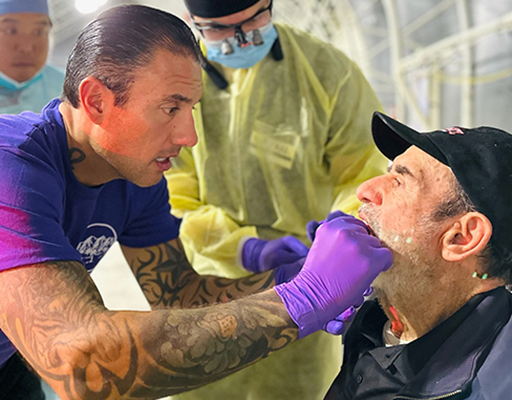 Dentist Examining Patient at Free Care Event