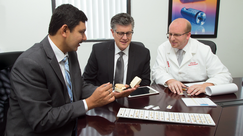 Dr. Park discusses implant prosthetics with Glidewell Laboratories Vice President of R&D Akash (left) and R&D Manager Tom Valenti (right).