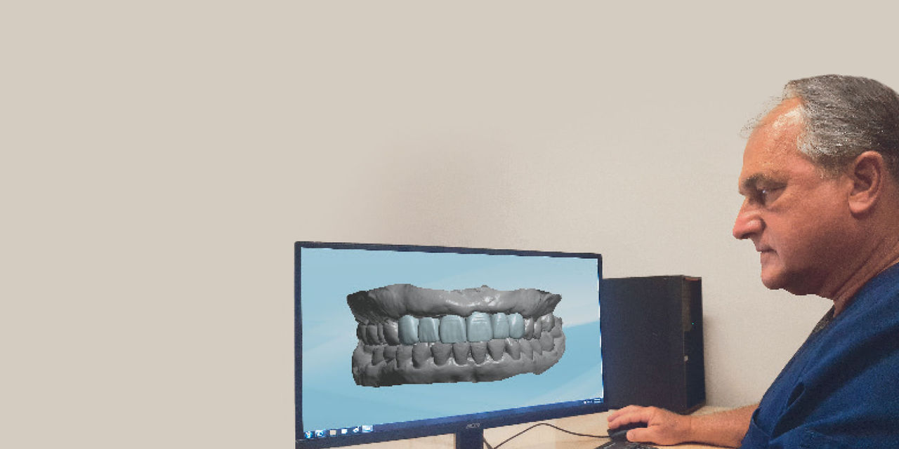 Dr. Jones using CAD/CAM fabrication software on his computer