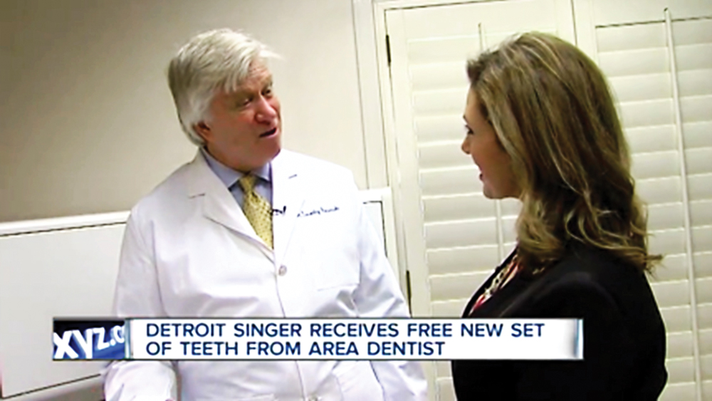A news reporter talks to Dr. Kosinski about the dental procedure