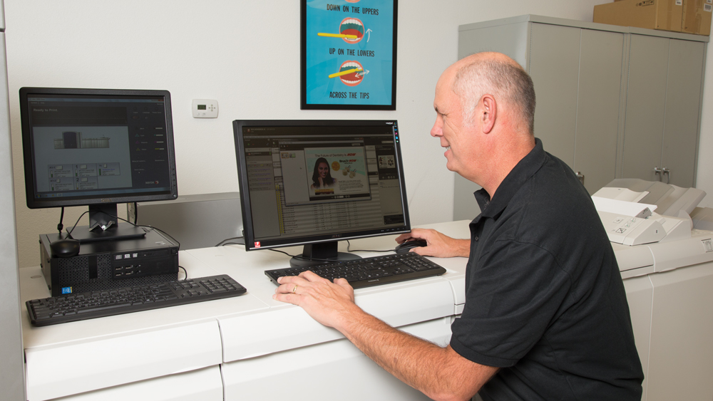 Randy Jones using a computer for print production