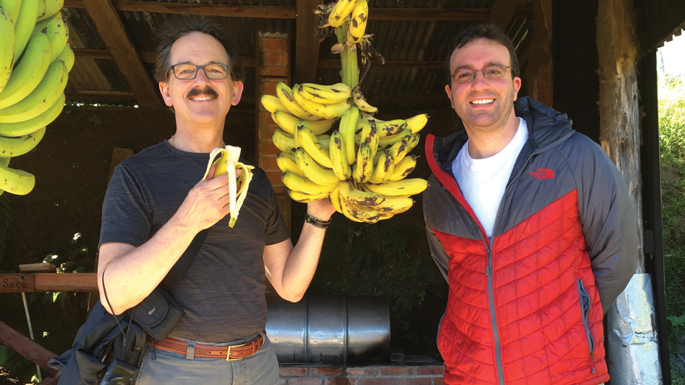 Dr. David Hochberg eating a banana and posing next to his son