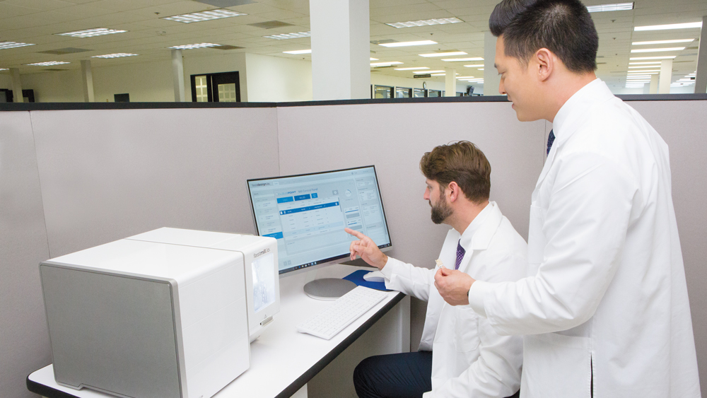 Dr. Chi working with dental lab worker using glidewell.io In-Office Solution