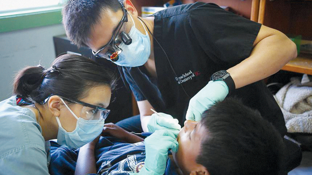 Dr. Chi working on a patient while in the Herman Ostrow School of Dentistry of USC