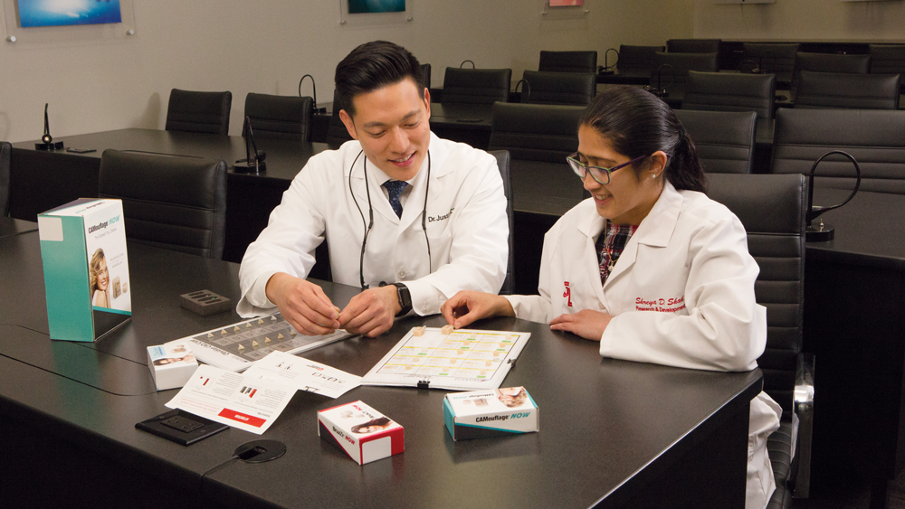 Dr. Chi working with a dental lab worker at the R&D Department