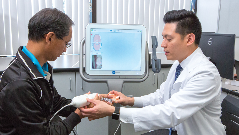 Dr. Justin Chi provides intraoral scanner training to clinician