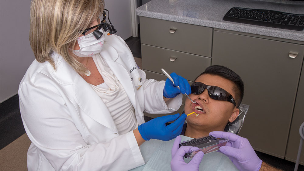 dentist opening patient mouth