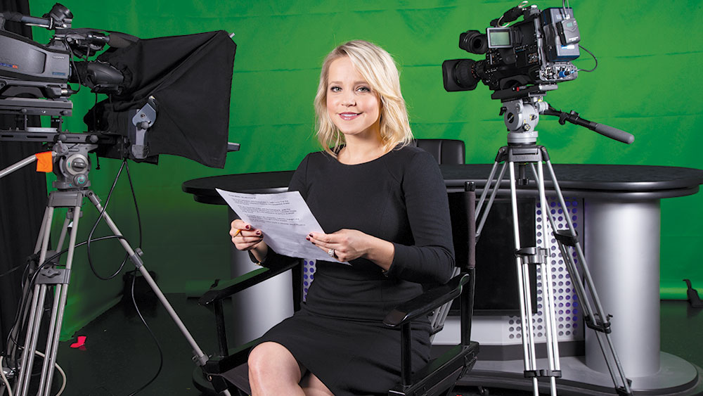 Megan Strong reviewing scripts on set