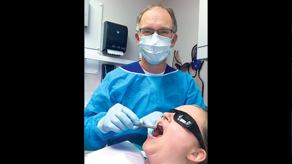 Dr. John Geasland placing an implant on a patient