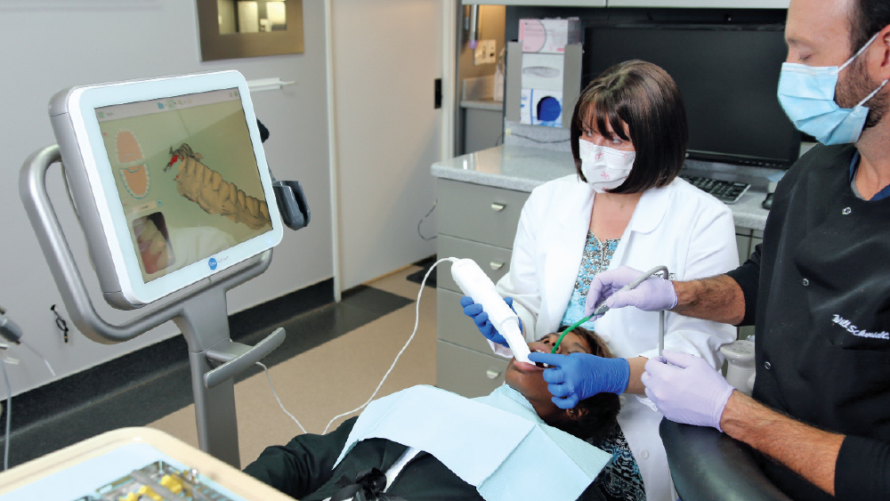 Dr. Muresan scans patient's teeth for a digital impression