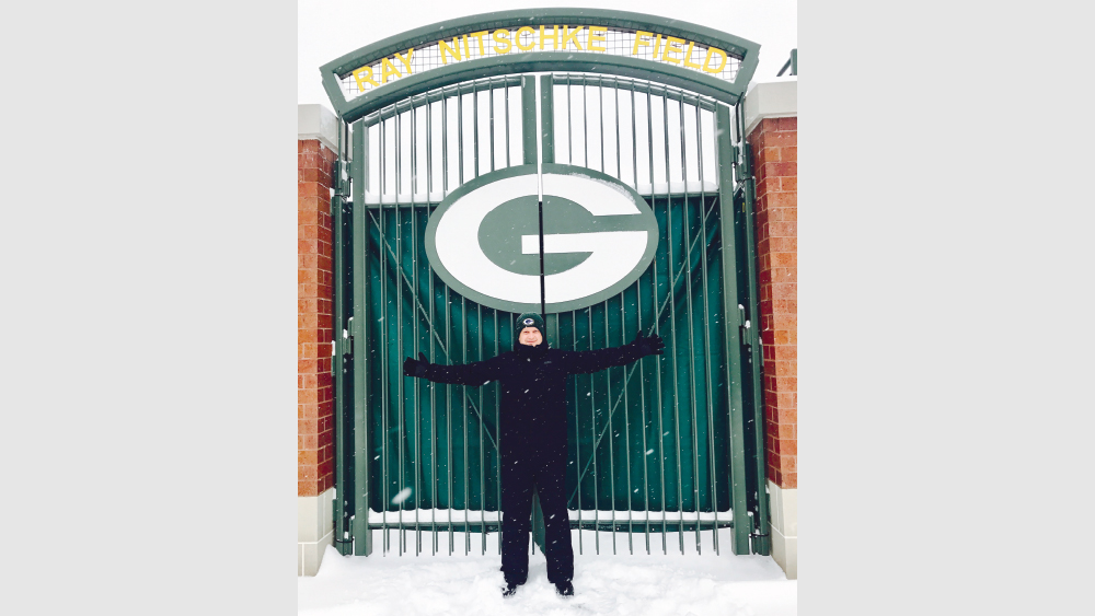 Darius in front of Green Bay Packers stadium gate during snow