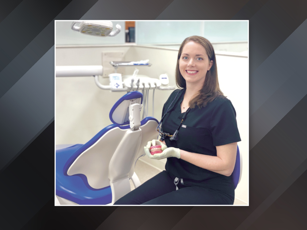 Patricia Swanson, DDS, FACP holding complete dentures