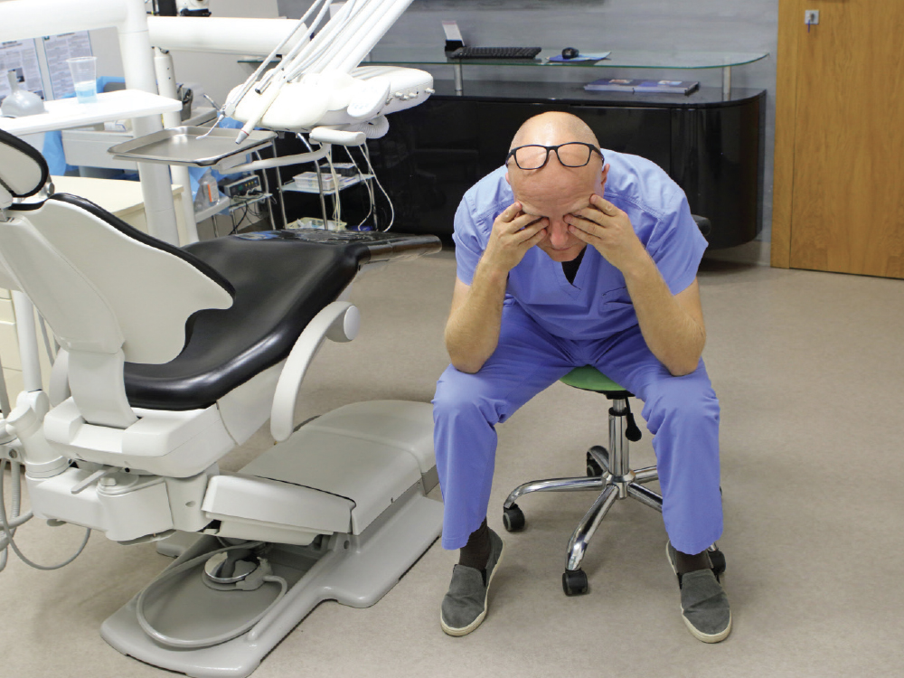 Fatigued dental staff sitting down