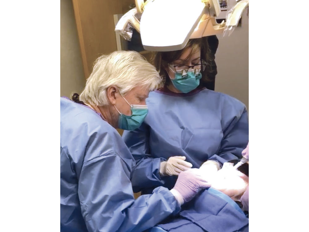 Dr. Kosinski guiding Dr. Tilley through a procedure.