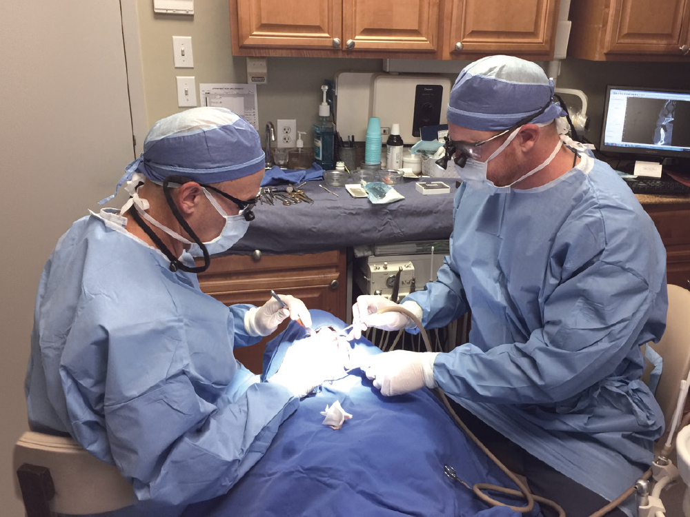 Two dentists working on a patient