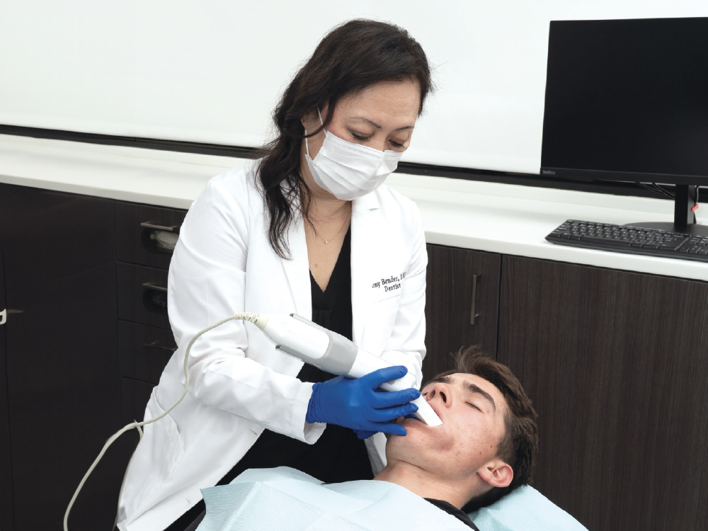 A dentist taking an impression on a patient