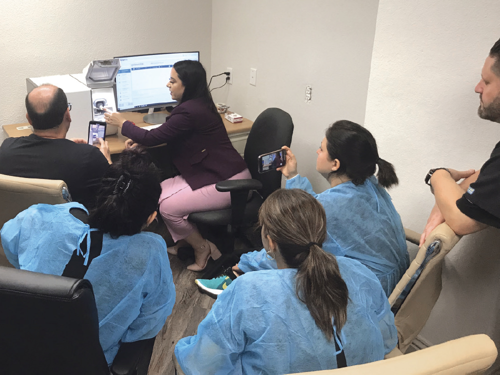 Logistics and Implementation Manager Samantha Montenegro explains key features of the fastmill.io to a dentist and his team on day two of the onsite implementation process