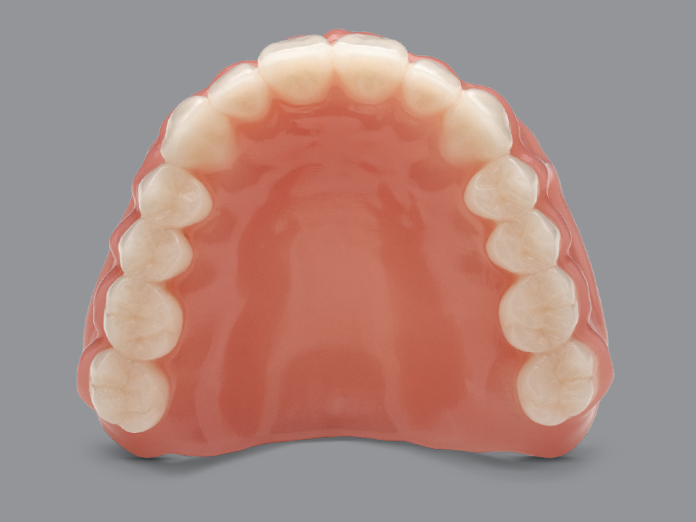 Upper dental prosthetic on gray background
