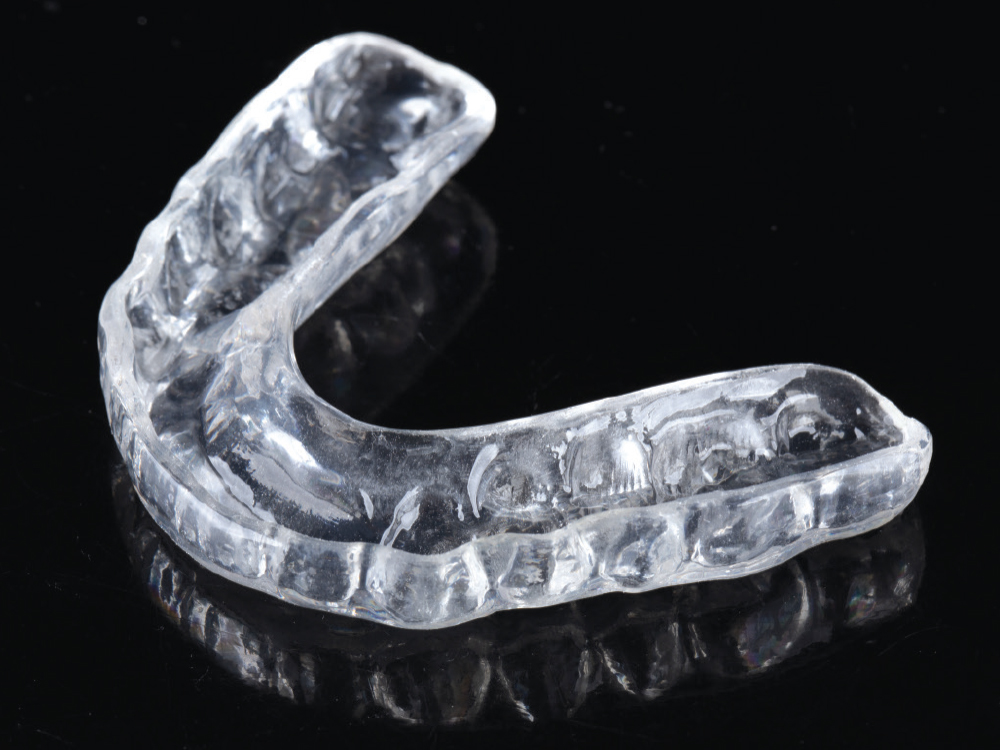 Clear dental mouthguard on black background