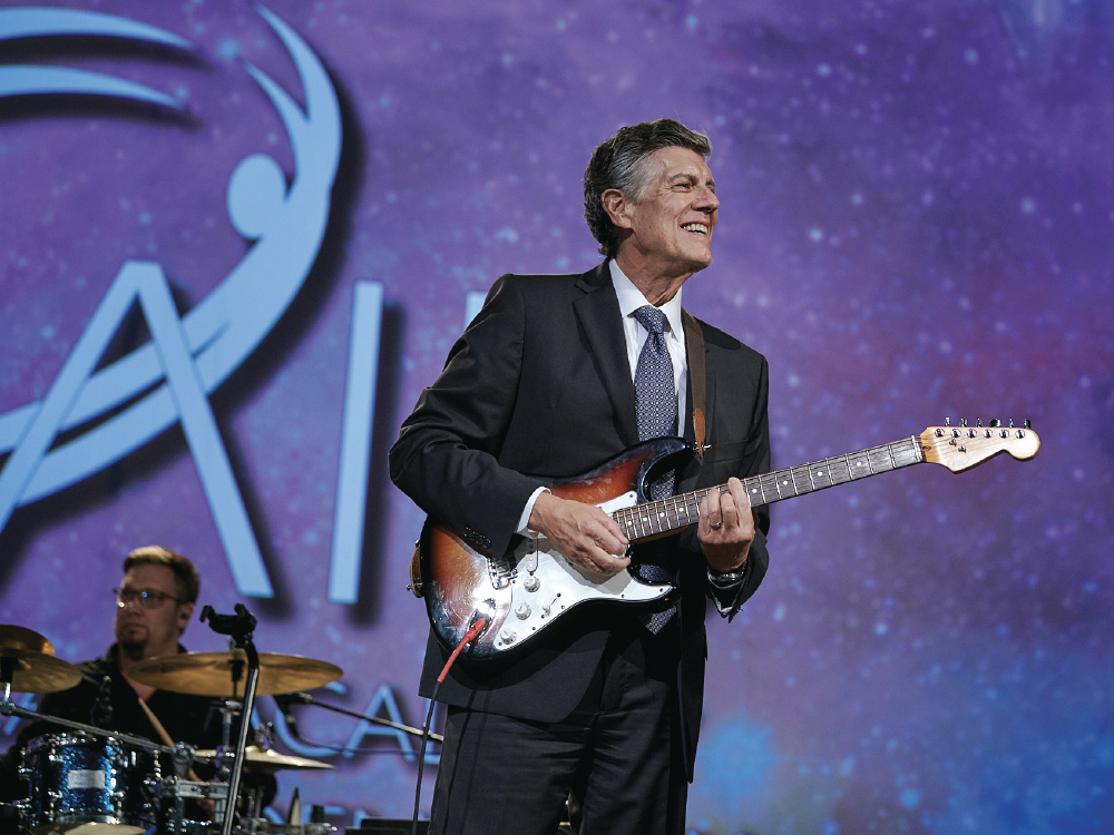 Dr. Park playing guitar at AAID