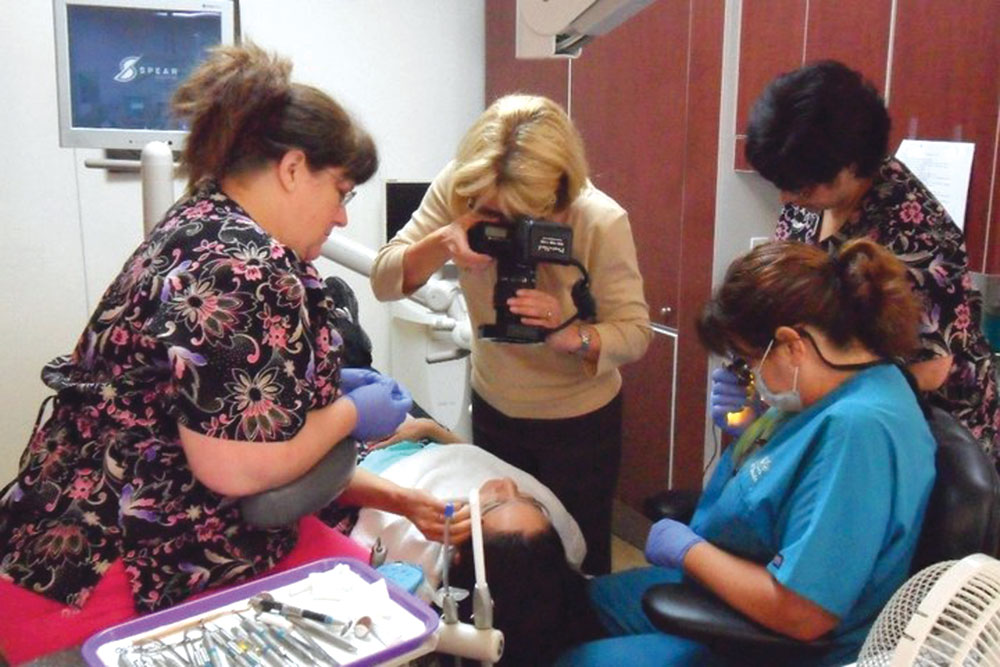 Dr. Lee Ann Brady taking photos of a patients mouth