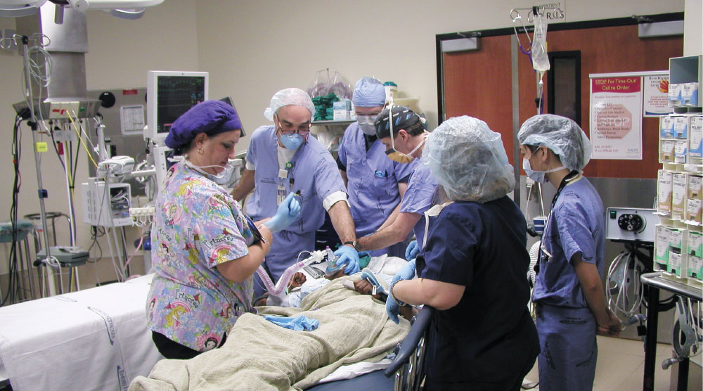 Dr. John Harden working on a patient with his team