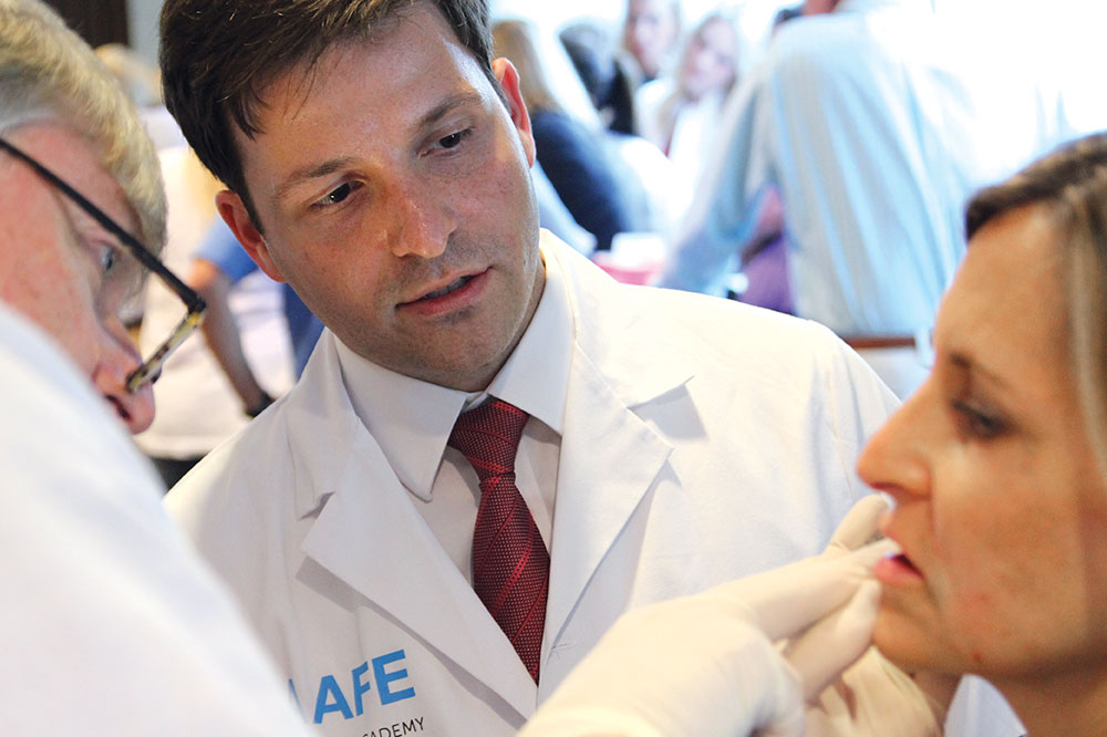 Two doctors examine patient's face