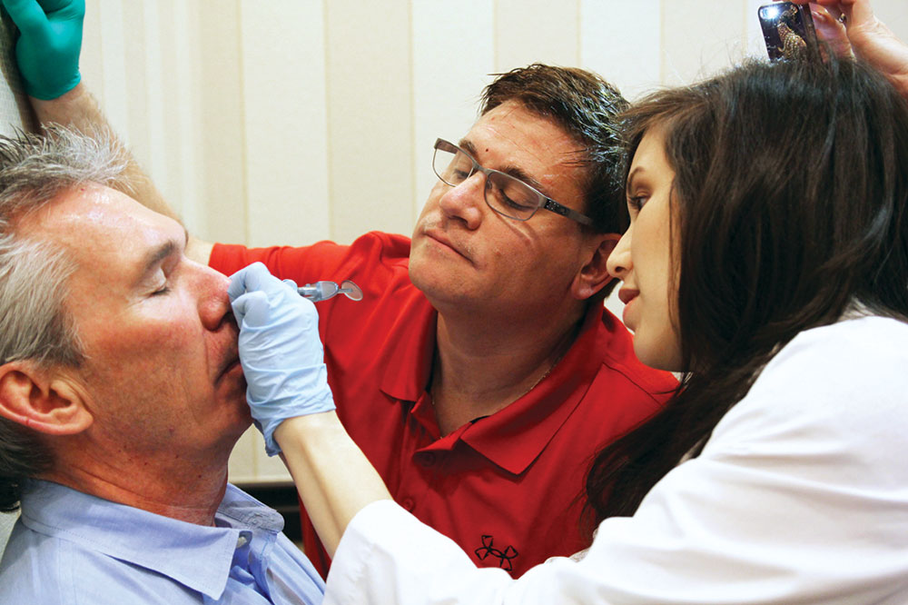 Doctor marking up facial area of patient