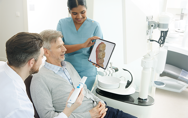 Dentist Showing Scan On iPad to Patient